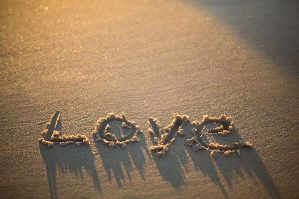 love written on the beach at the sunset